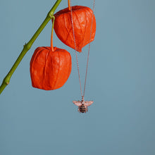 Honey Bee Rose Gold Pendant Necklace Hanging From Branch with Blue Sky