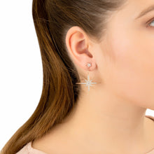 Woman Wearing Gold Starburst Drop Earrings