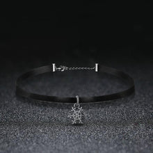 black choker necklace silver chain attachment snowflake pendant black background