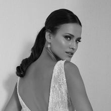 Black and White Image of Woman Wearing Gold Starburst Drop Earrings