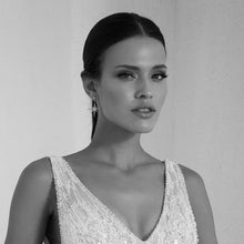 Black and White Image of Woman Wearing Gold Starburst Drop Earrings