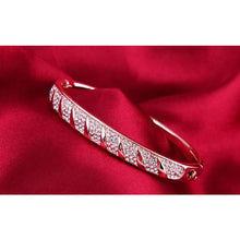 Rose Gold Bangle with Embedded Austrian Crystals close up red background