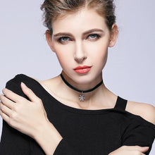 woman wearing black choker necklace silver chain attachment snowflake pendant front view