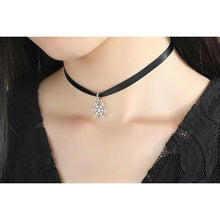 woman wearing black choker necklace with 925 sterling silver snowlflake pendant