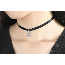 woman wearing black choker necklace with 925 sterling silver royal crown pendant