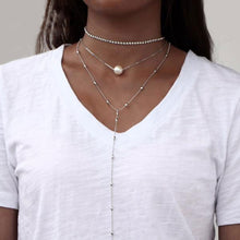 Woman Wearing Lengthy Choker Necklace with Simulated Pearl