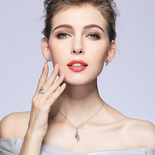 Woman Wearing Silver Necklace & Feather Shaped CZ Pendant