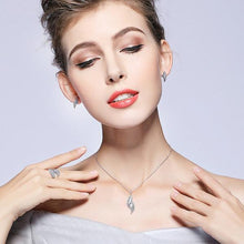 Woman Wearing Silver Necklace & Feather Shaped CZ Pendant